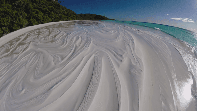 Clean beach with swirling sand