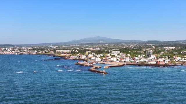 Coastal town with mountains in the background