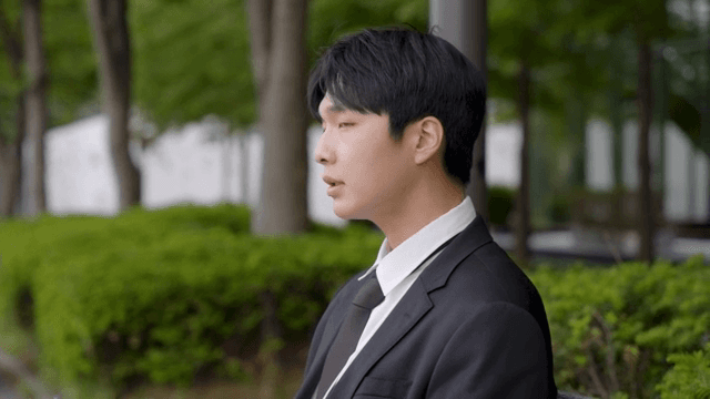 벤치에 앉아 커피를 마시며 숨을 고르는 남성