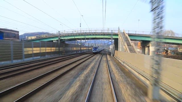 High-speed train running fast on the tracks on a sunny day