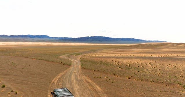 Vehicle traveling through a vast desert