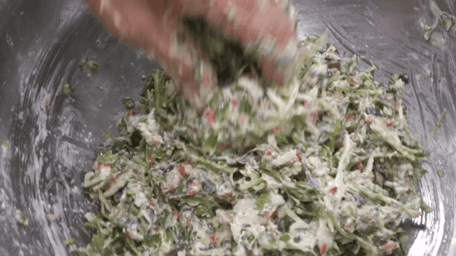 Cilantro pancake batter being mixed in bowl