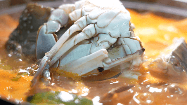 Crab being cooked in a spicy broth