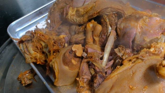 Steaming pig's feets on a metal tray