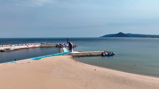 Scenic beach with a unique lighthouse and sculpture