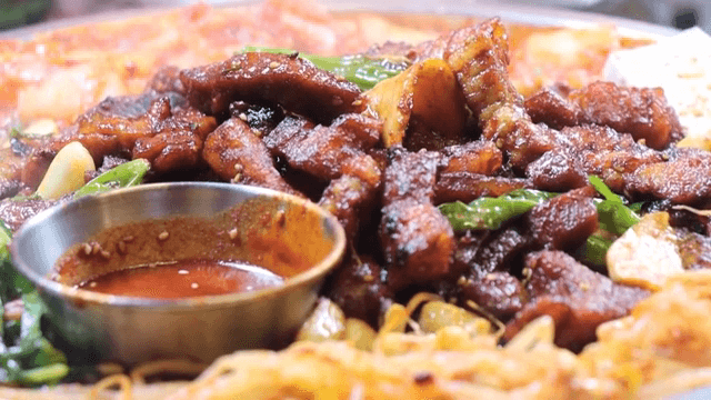 Korean barbecue with sizzling meat and kimchi