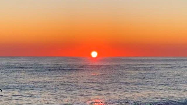 Serene Sunset Over Calm Sea Waters