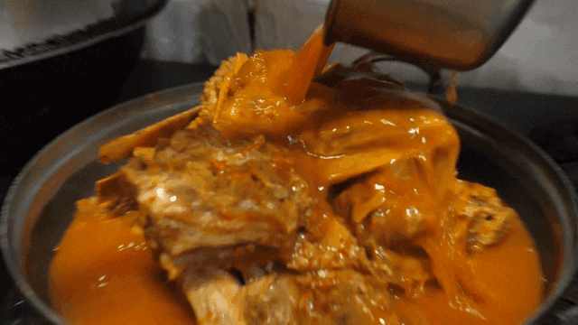 Pouring Seasoned Broth into Pork Backbone Stew