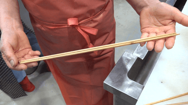 Chef inspecting wooden cooking chopsticks