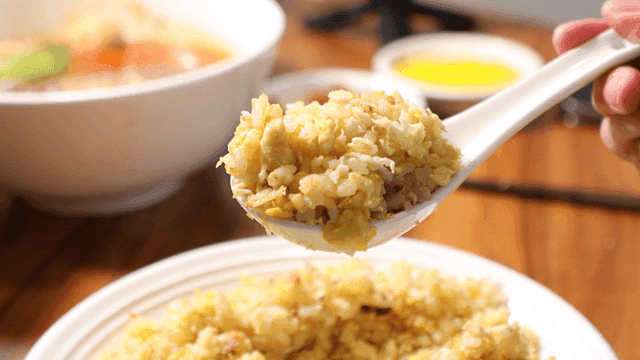 Spoonful of warm egg fried rice