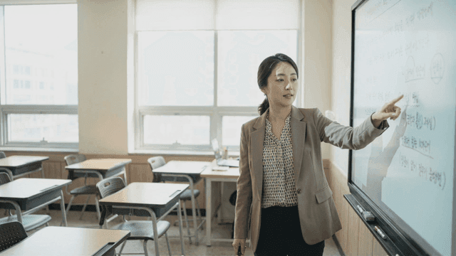 Teacher explaining on digital board