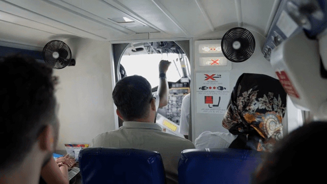 Passengers seated inside a small airplane
