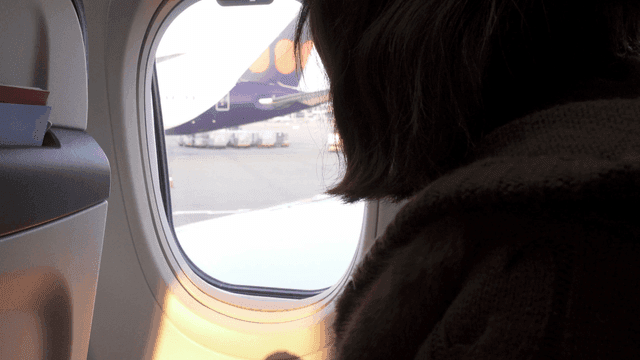 A person looking out an airplane window