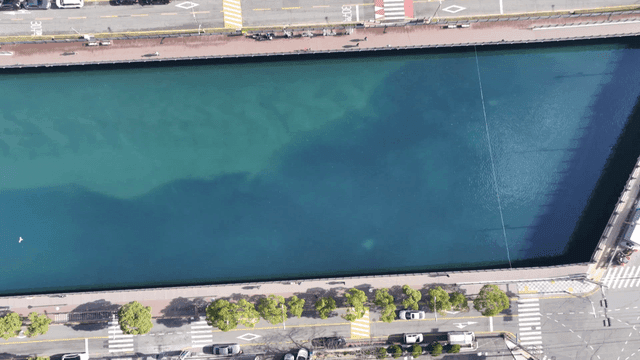 Blue river flowing between roads