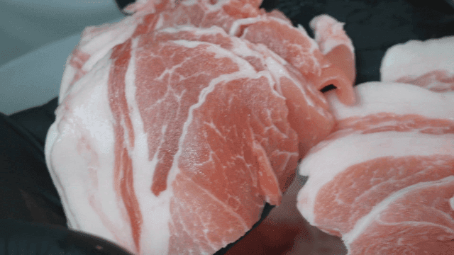 Fresh pork on gloves