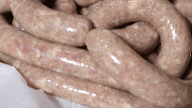 Freshly made sausages on a tray