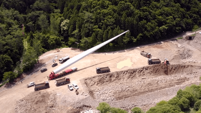 Transporting wind turbine materials at a construction site in the mountains