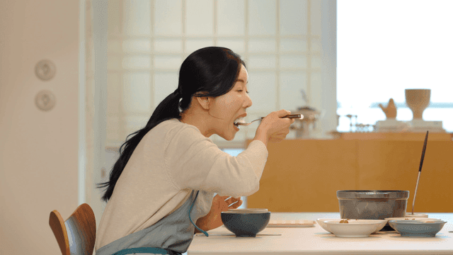 Woman eating breakfast at home