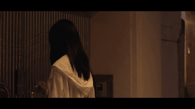 Woman entering the front door of a house