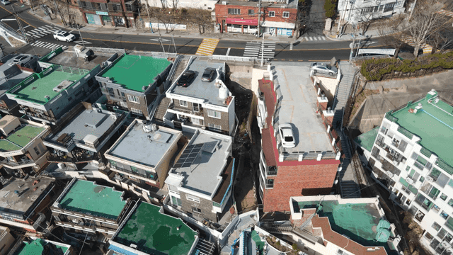 Aerial view of a residential area with cars