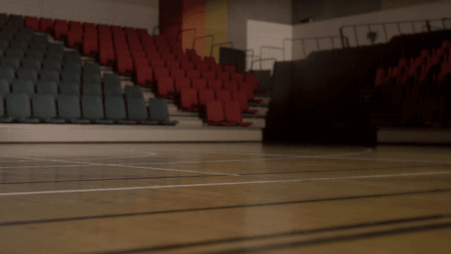 Athletes running in empty gym