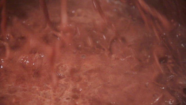 Thick red bean soup bubbling in a pot