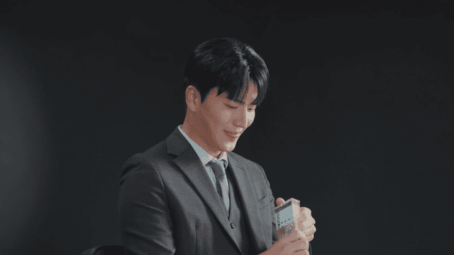Man in a suit counting money with a smile