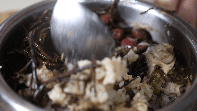 Bowl of stone pot rice with vegetables