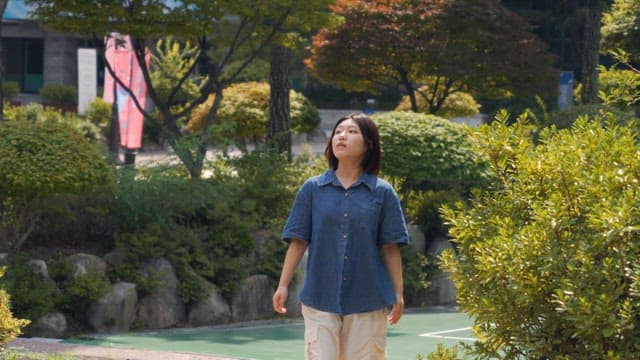 Woman enjoying a walk in a sunny garden