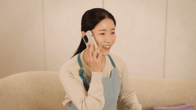 Woman smiling while talking on the phone