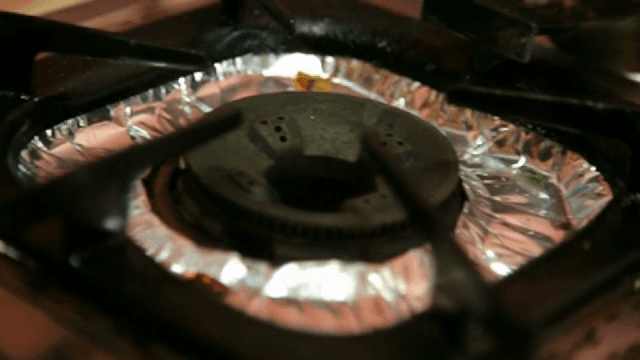 Gas stove with foil cover