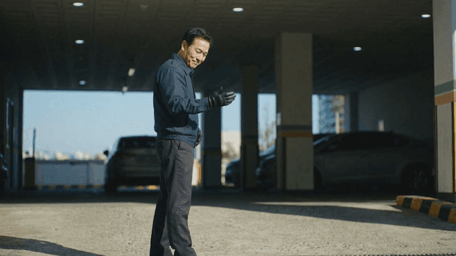 Security guard guiding vehicles in parking lot