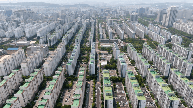 Aerial view of large apartment complex and city landscape