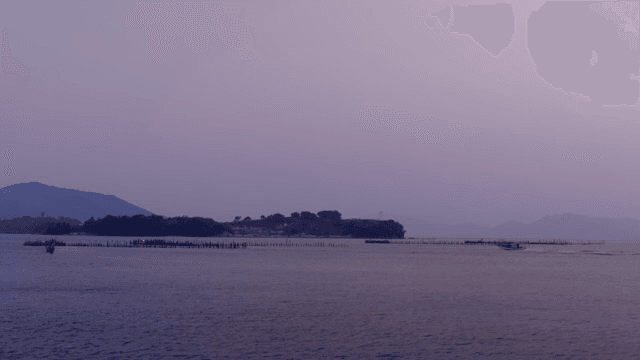 A tranquil sea with distant islands