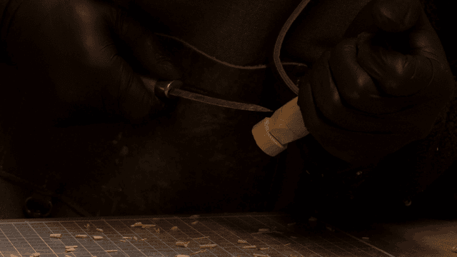 Artisan carving wood precisely with a knife