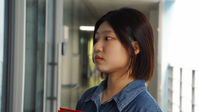 Young woman smiling in a hallway