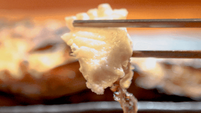 Grilled fish dipped in salt and eaten with chopsticks