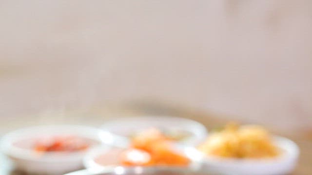 Bowl of Korean red bean noodle with side dishes