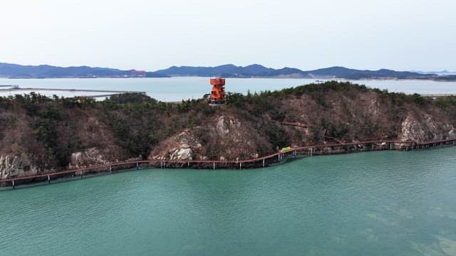 Unique orange tower on a coastal hill