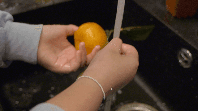 Washing tangerines in running water