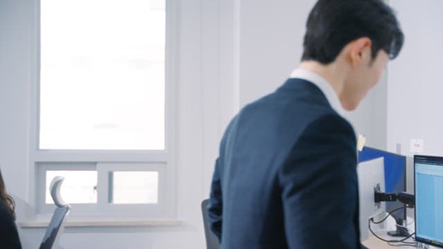 Man sitting at his office desk and talking on the phone