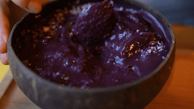 Bowl of purple acai bowl with toppings