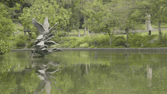 Tranquil park with lake and statues