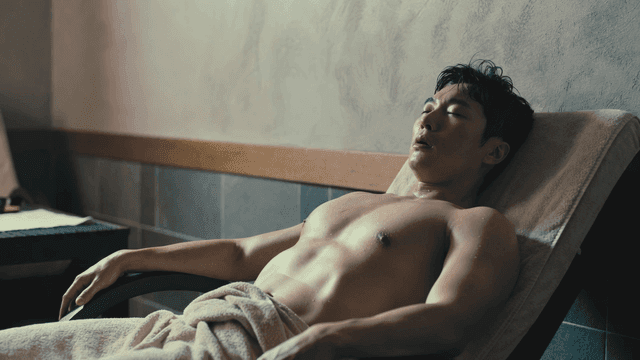 Man relaxing in a sauna with a towel