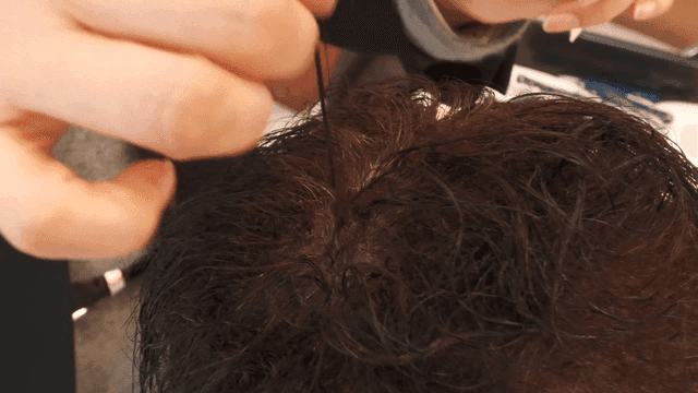 Hair being styled with a comb