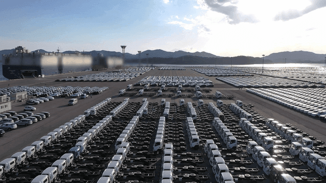 Large parking lot filled with cars.