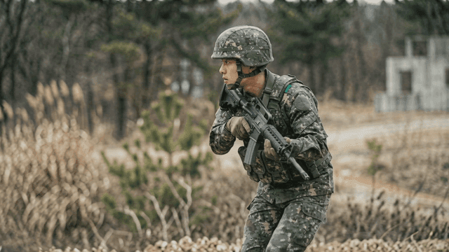 Soldier carrying rifle on duty