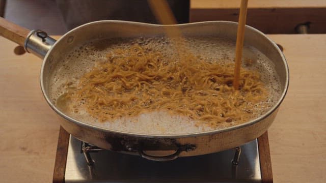 Ramen noodles boiling in a pot