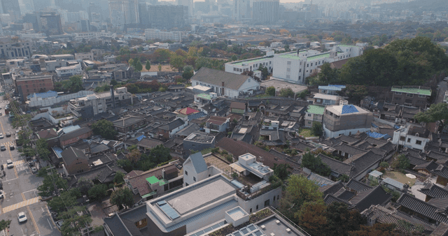 Panoramic view of a Hanok village lined with traditional tiled roofs
