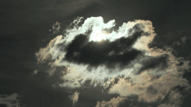 Sunlight breaking through dark clouds
